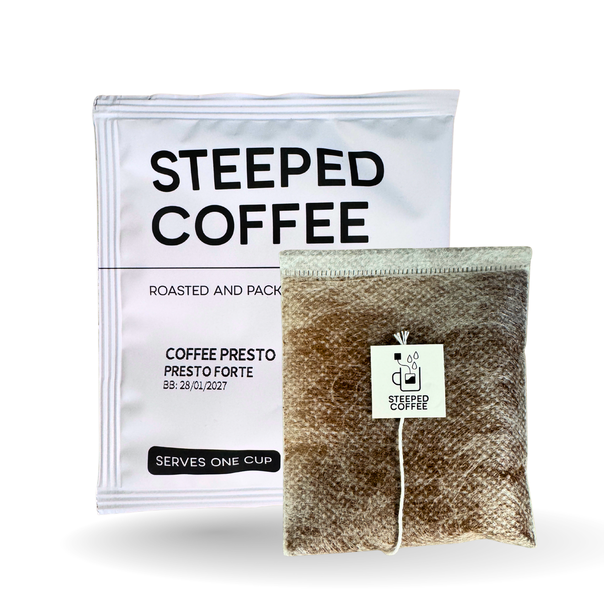 A package of Steeped Coffee Roasted and Packaged coffee next to a single brewed coffee bag with a white tag, on a clean white background.